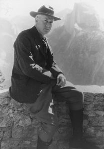 Stephen T. Mather, first Director of the National Parks Service, seated in front of Yosemite National Park's iconic Half Dome.