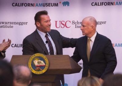 Former Gov. Arnold Schwarzenegger shakes hands with Gov. Jerry Brown as they celebrate the 10th anniversary of AB 32. (Sacramento Bee)