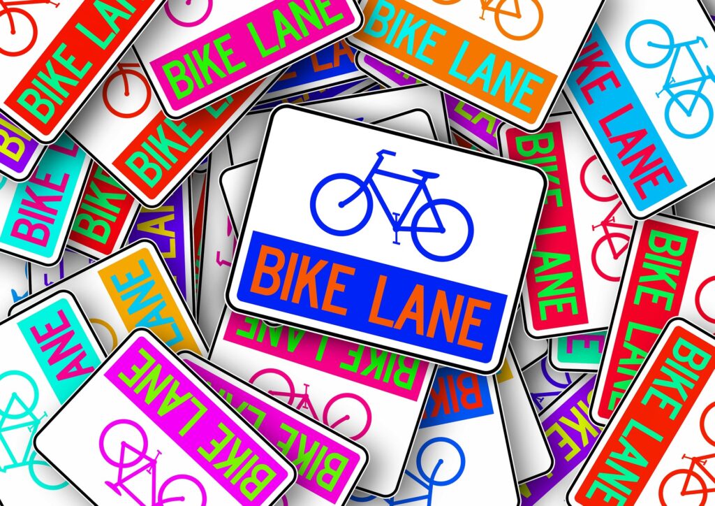 A colorful pile of Bike Lane signs